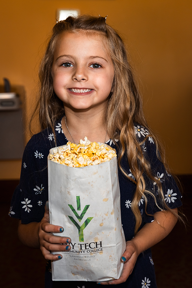 Attendee with complimentary Ivy Tech popcorn at Film Fest