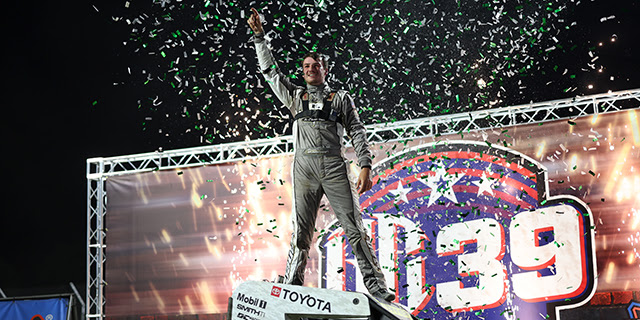 Briggs Danner celebrates atop his car in Victory Lane after winning the BC39 at The Dirt Track at Indianapolis Motor Speedway