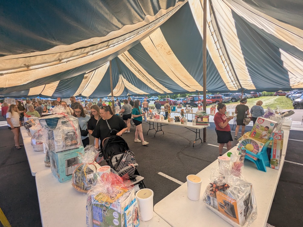 Festival-goers browse raffle baskets at the 2025 St. Anthony of Padua Labor Day Festival in Morris